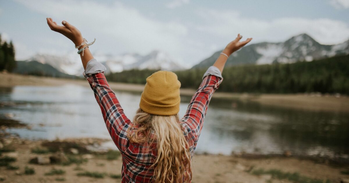 Woman, hands in air, expressing amor fati, love your fate, acceptance