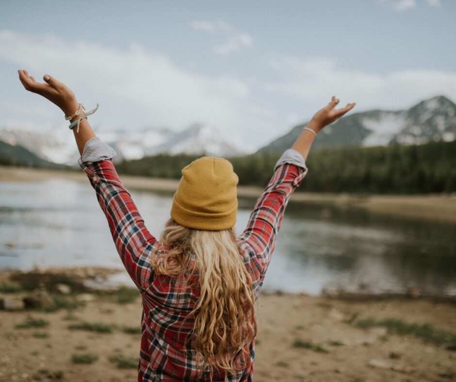 Woman, hands in air, expressing amor fati, love your fate, acceptance