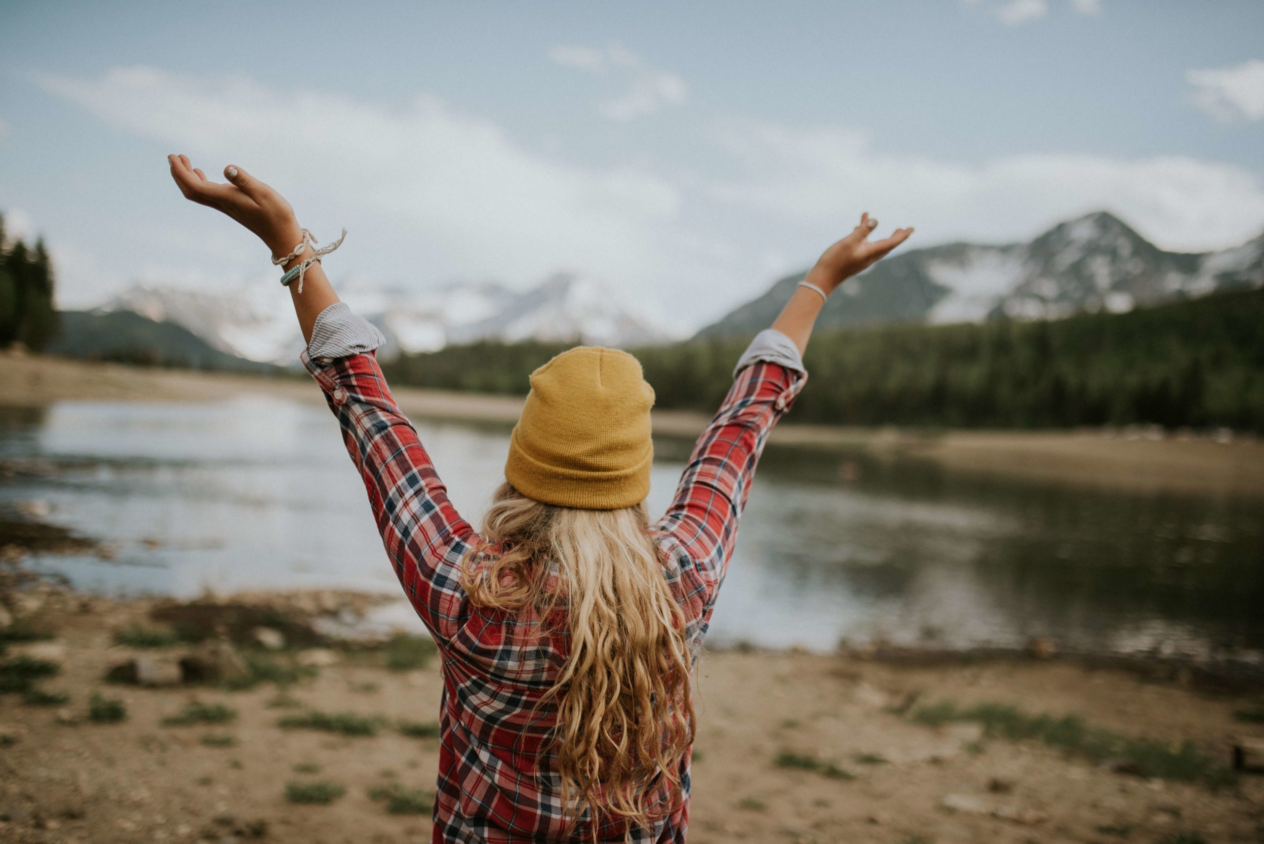 Woman, hands in air, expressing amor fati, love your fate, acceptance