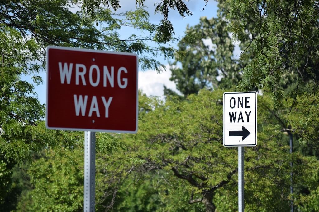Street signs Wrong way and One way