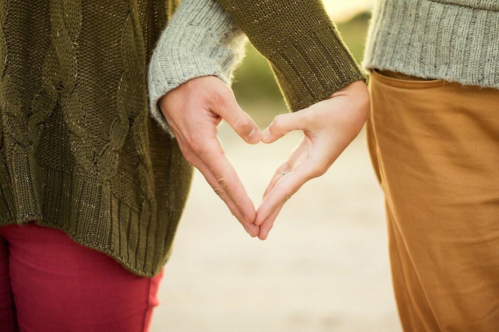 Couple holding hands in the shape of a heart