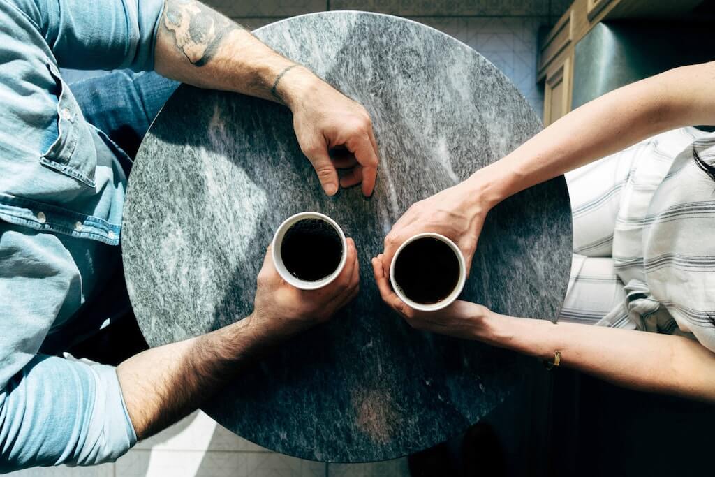 Two people having coffee discussing boundaries