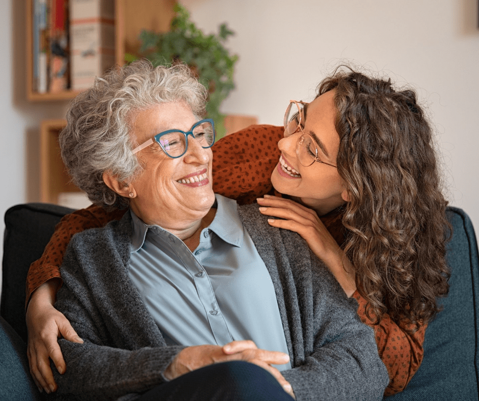 Two women embracing each other. One is the caregiver