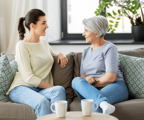 Woman and mother having conversation over coffee